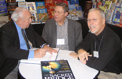 Anson Rainey and Steven Notley autograph a copy of The Sacred Bridge, Carta's Atlas of the Biblical World, for Ferrell Jenkins at the annual meeting, 2007.